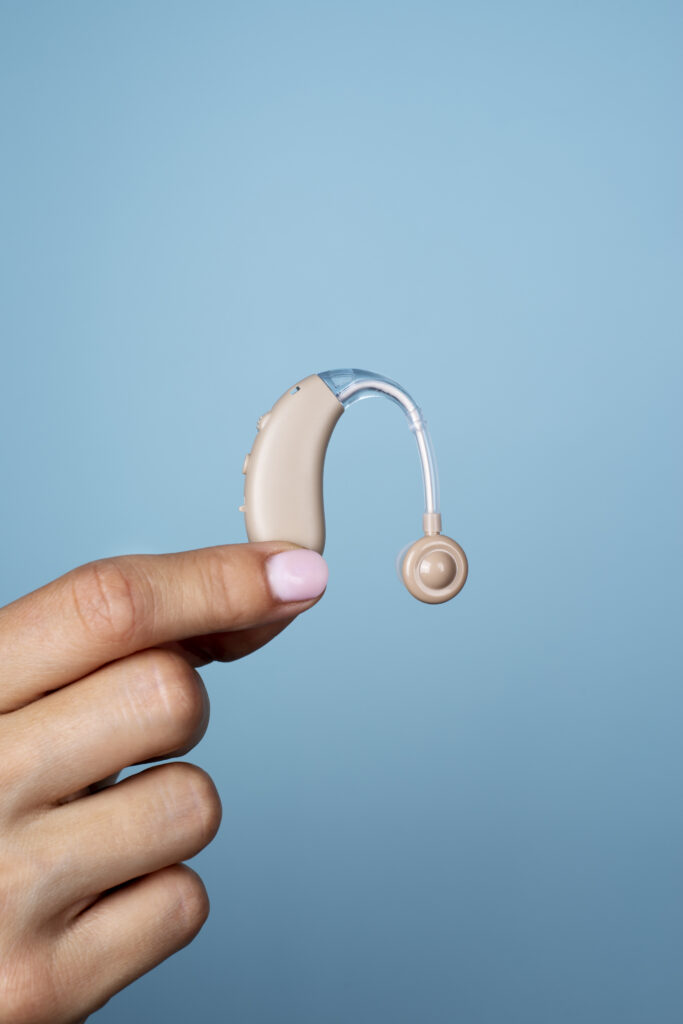 Side View Hand Holding Hearing Aids